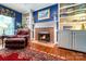 Cozy living room featuring a brick fireplace, built-in shelving, and a comfortable leather recliner at 3412 Country Club Dr, Gastonia, NC 28056