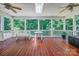 Open-air screened porch with white benches and peaceful wooded views at 3412 Country Club Dr, Gastonia, NC 28056