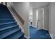 Carpeted staircase leads to finished basement, offering a spacious transition with a classic design at 3412 Country Club Dr, Gastonia, NC 28056
