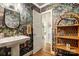 Bathroom with unique jungle wallpaper, white vanity and a wooden shelf at 3726 Providence Rd, Charlotte, NC 28211