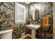 Powder room featuring a pedestal sink, jungle wallpaper and natural light at 3726 Providence Rd, Charlotte, NC 28211