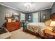 A bedroom with a large bed, complemented by a dresser and unique wall decor, offering a cozy and personalized space at 3726 Providence Rd, Charlotte, NC 28211