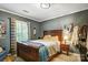 Bedroom featuring a wooden bed frame, complemented by a lamp and distinctive wall art, enhancing the room's character at 3726 Providence Rd, Charlotte, NC 28211