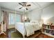 Bright bedroom with a four poster bed, hardwood floors, and plantation shutters at 3726 Providence Rd, Charlotte, NC 28211
