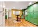 Cozy dining area featuring green cabinetry, a round table with seating, and hardwood floors at 3726 Providence Rd, Charlotte, NC 28211