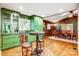 Stylish dining area adjacent to the kitchen with unique green cabinets and convenient bar space at 3726 Providence Rd, Charlotte, NC 28211