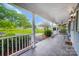 Relaxing front porch with views of the lush lawn and street, complemented by stylish light fixtures at 3726 Providence Rd, Charlotte, NC 28211