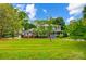 A beautiful lawn surrounds this charming home with an inviting front porch and lush, mature trees at 3726 Providence Rd, Charlotte, NC 28211