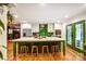 Modern kitchen with a large island, white cabinets, green backsplash, and stainless steel appliances at 3726 Providence Rd, Charlotte, NC 28211
