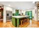 Spacious kitchen featuring a large island with seating, white cabinets, and modern stainless steel appliances at 3726 Providence Rd, Charlotte, NC 28211