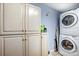 Functional laundry room with stackable washer/dryer and plenty of storage cabinets at 3726 Providence Rd, Charlotte, NC 28211