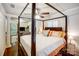 Spacious main bedroom boasts a large four poster bed, ceiling fan, and seamlessly connects to an adjacent sitting area at 3726 Providence Rd, Charlotte, NC 28211