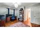This is a home office with wood floors, chandelier and natural light from the windows at 3726 Providence Rd, Charlotte, NC 28211