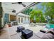 Inviting covered patio with stylish furniture, ceiling fans, and a view of the pool and lush backyard at 3726 Providence Rd, Charlotte, NC 28211