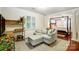 Sitting room with a gray sofa, light streaming through the shutters, with view to the large main bedroom at 3726 Providence Rd, Charlotte, NC 28211