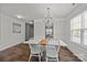 Open dining room features neutral paint, a traditional chandelier and large sunny windows at 3908 Parkers Ferry Rd, Fort Mill, SC 29715