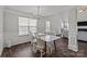 Dining room features an elegant chandelier, large windows, and classic white wainscoting at 3908 Parkers Ferry Rd, Fort Mill, SC 29715