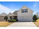 Charming two-story home with a two-car garage, well-manicured lawn, and inviting curb appeal under a clear, blue sky at 3908 Parkers Ferry Rd, Fort Mill, SC 29715