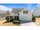 Traditional two-story home with a two-car garage, inviting front porch, and well-maintained landscaping on a sunny day at 3908 Parkers Ferry Rd, Fort Mill, SC 29715