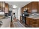 Spacious kitchen featuring wood cabinetry, modern appliances, and seamless transition to the dining area and living room at 3908 Parkers Ferry Rd, Fort Mill, SC 29715