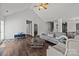 Bright living room with a fireplace, vaulted ceilings, plush seating, and dark wood floors at 3908 Parkers Ferry Rd, Fort Mill, SC 29715
