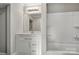 Bright bathroom featuring a marble vanity, mirror, and tub at 4 Short St, Belmont, NC 28012