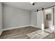 Bedroom with a bathroom attached featuring a sliding barn door at 4 Short St, Belmont, NC 28012