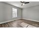 This bedroom features wood floors, a ceiling fan, and a window at 4 Short St, Belmont, NC 28012