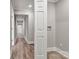 Hallway with neutral paint, white trim, and wood floors at 4 Short St, Belmont, NC 28012