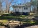 Back exterior view of a white home on a lot with mature trees at 406 E Earnhardt St, Salisbury, NC 28144