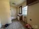 This bathroom features a shower-tub combo, a sink with vanity, and a tile floor at 406 E Earnhardt St, Salisbury, NC 28144