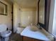 This bathroom features a shower-tub combo, a sink with vanity, and a toilet at 406 E Earnhardt St, Salisbury, NC 28144
