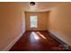 This bedroom features wood floors, natural light, and a neutral color scheme at 406 E Earnhardt St, Salisbury, NC 28144