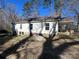 Back exterior view of a one-story home showing the backyard and natural setting at 406 E Earnhardt St, Salisbury, NC 28144
