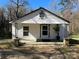 Charming single-story home with a covered porch, white siding, and classic architectural details at 406 E Earnhardt St, Salisbury, NC 28144