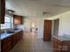This kitchen features granite countertops, a double sink, and wooden cabinets at 406 E Earnhardt St, Salisbury, NC 28144