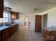 This kitchen features granite countertops, a double sink, and wooden cabinets at 406 E Earnhardt St, Salisbury, NC 28144