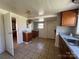 A kitchen features granite countertops, wooden cabinets, and a double sink at 406 E Earnhardt St, Salisbury, NC 28144