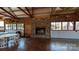 Spacious hall featuring a stone fireplace, wood beams, and ample seating arrangement at 4229 Motocross Trl, Edgemoor, SC 29712