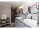 Modern bathroom featuring double sinks, wood-look tile flooring, and a luxurious, tiled walk-in shower at 4229 Motocross Trl, Edgemoor, SC 29712