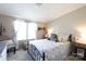 Inviting bedroom with a decorative bed frame, neutral walls, floral bedding, and natural light from large windows at 4229 Motocross Trl, Edgemoor, SC 29712