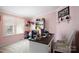 Cozy bedroom with a desk, window, soft pink walls and charming doll and book display shelves at 4229 Motocross Trl, Edgemoor, SC 29712