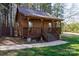 Charming cabin with inviting front porch and steps surrounded by trees at 4229 Motocross Trl, Edgemoor, SC 29712