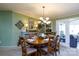 Charming dining room features a round wood table with six chairs, a decorative chandelier, and inviting decor at 4229 Motocross Trl, Edgemoor, SC 29712