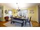 Warm dining room with hardwood floors, table set for gathering, and decorative floral and bird accents at 4229 Motocross Trl, Edgemoor, SC 29712