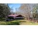 Exterior view of a covered outdoor event space with metal roof and wooden support beams at 4229 Motocross Trl, Edgemoor, SC 29712