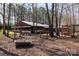 Exterior view of covered event space with seating and tub in wooded setting at 4229 Motocross Trl, Edgemoor, SC 29712