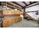 Large garage with built-in cabinets, sink, shelving, and convenient staircase at 4229 Motocross Trl, Edgemoor, SC 29712