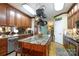 Beautiful kitchen with granite countertops, wood cabinetry, a center island, and stainless steel appliances at 4229 Motocross Trl, Edgemoor, SC 29712