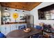 Charming outdoor kitchen with stainless steel refrigerator, mounted TV, and dining table at 4229 Motocross Trl, Edgemoor, SC 29712